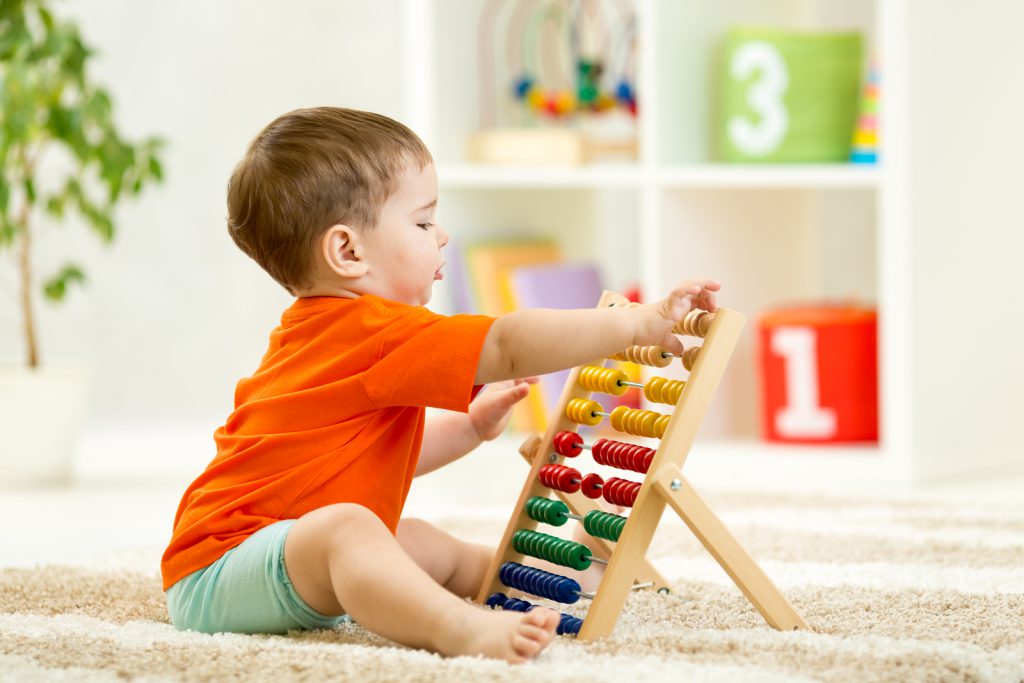 child boy playing with counter toy at home