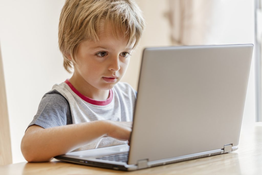 Young boy working on a laptop