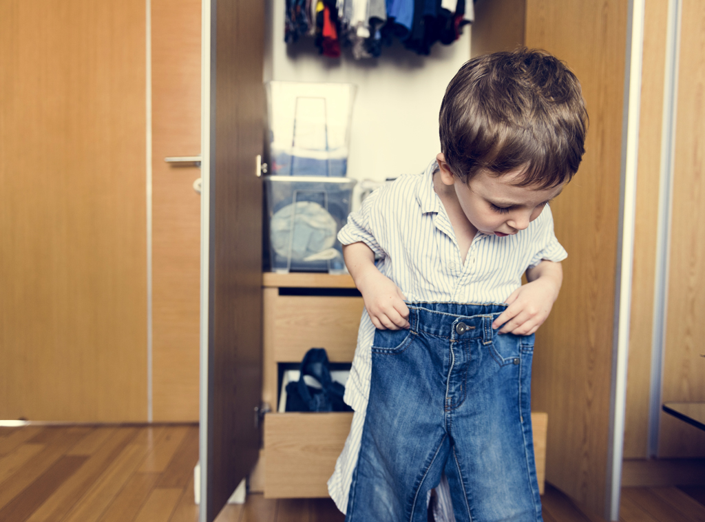 Child getting dressed by himself